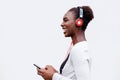 Profile of happy young black woman listening to music with smart phone and headphones Royalty Free Stock Photo