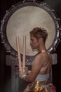 Profile portrait of a Japanese drummer Taiko with drumsticks