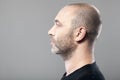 Profile portrait of man on gray background