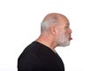 Profile Portrait, Middle-Aged Bearded Man in Black T-Shirt Sticking Out Tongue - Playful Humor on White Background Royalty Free Stock Photo