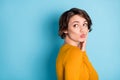 Profile portrait of nice optimistic brunette lady blow kiss look empty space wear yellow shirt isolated in vivid blue