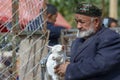 Profile portrait of old man with young goat, Sunday Livestock Ma