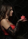 Profile portrait shot of brunette woman holding a candle in the dark Royalty Free Stock Photo