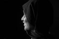 Profile portrait of a woman with burqa on black background Royalty Free Stock Photo