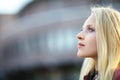 Profile portrait of young beautiful blond woman in city street o Royalty Free Stock Photo