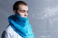Profile portrait of a young man covered part of face with blue plastic bag, shot in studio. Copy space Royalty Free Stock Photo