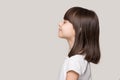 Profile of serene little girl isolated on grey studio background Royalty Free Stock Photo