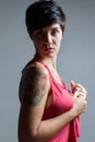 Profile of a short-hair brunette woman, wearing a red tank top h Royalty Free Stock Photo