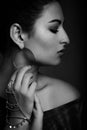 Profile shot of a beautiful young model holding touching her ear ring