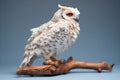 profile shot of a snowy owl sitting on a snow-covered branch Royalty Free Stock Photo