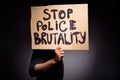 Profile side photo of afro american guy hold banner stop police brutality close cover hide head anonymous rebellion wear Royalty Free Stock Photo