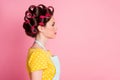 Profile side photo of attractive girl look copyspace wear retro outfit hair rollers  over pink color background Royalty Free Stock Photo