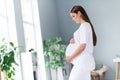 Profile side photo of beautiful mommy pregnant girl waiting for her firstborn newborn baby touching big tummy flat
