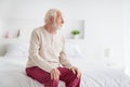 Profile side photo of elderly man pensioner alone lonely sit bed home unhappy sad upset look empty space