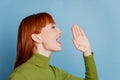 Profile side photo of girl tell message empty space isolated over blue background