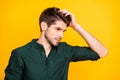 Profile side photo of serious minded guy look in mirror touch his hair after new anti dander effect shampoo wear casual