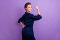 Profile side photo of smiling confident strong brave woman raise fist feminism isolated on purple color background