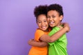 Profile side photo of two young little afro kids happy positive smile hug cuddle isolated over violet color background Royalty Free Stock Photo