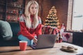 Profile side photo of young attractive girl happy positive smile use laptop typing email congratulation holiday indoors