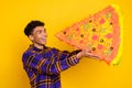 Profile side photo of young black guy happy smile eat big slice tasty italian pizza isolated over yellow color