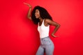 Profile side photo of young excited african girl happy positive smile have fun dance playful isolated over red color Royalty Free Stock Photo