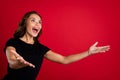 Profile side photo of young excited girl open arms look empty space catch isolated over red color background Royalty Free Stock Photo