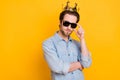 Profile side photo of young serious man hand touch glasses royalty prince isolated over yellow color background Royalty Free Stock Photo