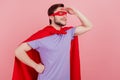 Profile side photo of young superman look forward ahead brave dangerous isoalted over pink color background