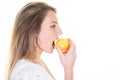 Profile side portrait of beauty cheerful young blonde woman eating red yellow apple