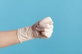 Profile side view closeup of human hand in white surgical gloves showing gesture