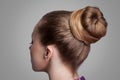 Profile side view closeup portrait of woman with creative elegant brown collected hairstyle, bun hair Royalty Free Stock Photo