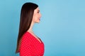 Profile side view portrait of attractive cheerful girl copy blank space glamour look isolated over vibrant blue color