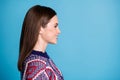 Profile side view portrait of attractive cheerful girl copy empty space ad isolated over vibrant blue color background