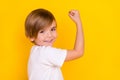 Profile side view portrait of attractive cheerful pre-teen boy having fun great news  over bright yellow color Royalty Free Stock Photo