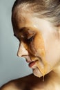 Profile side view portrait of beautiful young brunette woman with freckles and honey on face with closed eyes and smiley happy Royalty Free Stock Photo