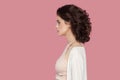 Profile side view portrait of calm beautiful brunette young woman with curly hairstyle in casual style standing with serious face Royalty Free Stock Photo