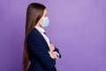 Profile side view portrait of content diligent long-haired girl folded arms healthy life wearing safety gauze mask mers