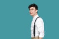 Profile side view portrait of happy handsome hipster curly young businessman in white shirt and suspender standing and looking at Royalty Free Stock Photo