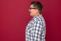 Profile side view portrait of happy handsome middle aged business man in casual checkered shirt, eyeglasses standing and looking Royalty Free Stock Photo