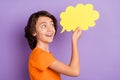 Profile side view portrait of nice amazed cheerful boy holding cloud copy space chat information isolated over violet Royalty Free Stock Photo