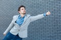 Profile side view portrait of serious handsome bearded man in casual style standing in superman gesture with fist and looking far Royalty Free Stock Photo