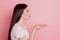 Profile side view portrait of sweet attractive lovely pretty girl sending air kiss empty space isolated over pink Royalty Free Stock Photo
