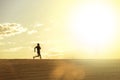 Profile silhouette of young man running in countryside training cross country jogging discipline in summer sunset