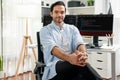 Profile smart IT developer looking camera against on coding pc screen. Surmise.