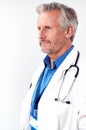 Profile Studio Shot Of Mature Male Doctor Wearing White Coat And Stethoscope On White Background