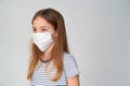 Profile teen girl in medical mask white background
