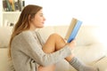 Profile of a teen reading a book at home