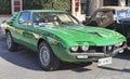 Profile view of a beautiful vintage green car model Alfa Romeo Montreal manufactured by Italian Alfa Romeo