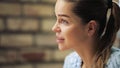 Profile view of beautiful woman listening an interlocutor in a cafe