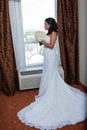 Profile view of a bride holding her bouquet by a window, bridal portrait side view Royalty Free Stock Photo